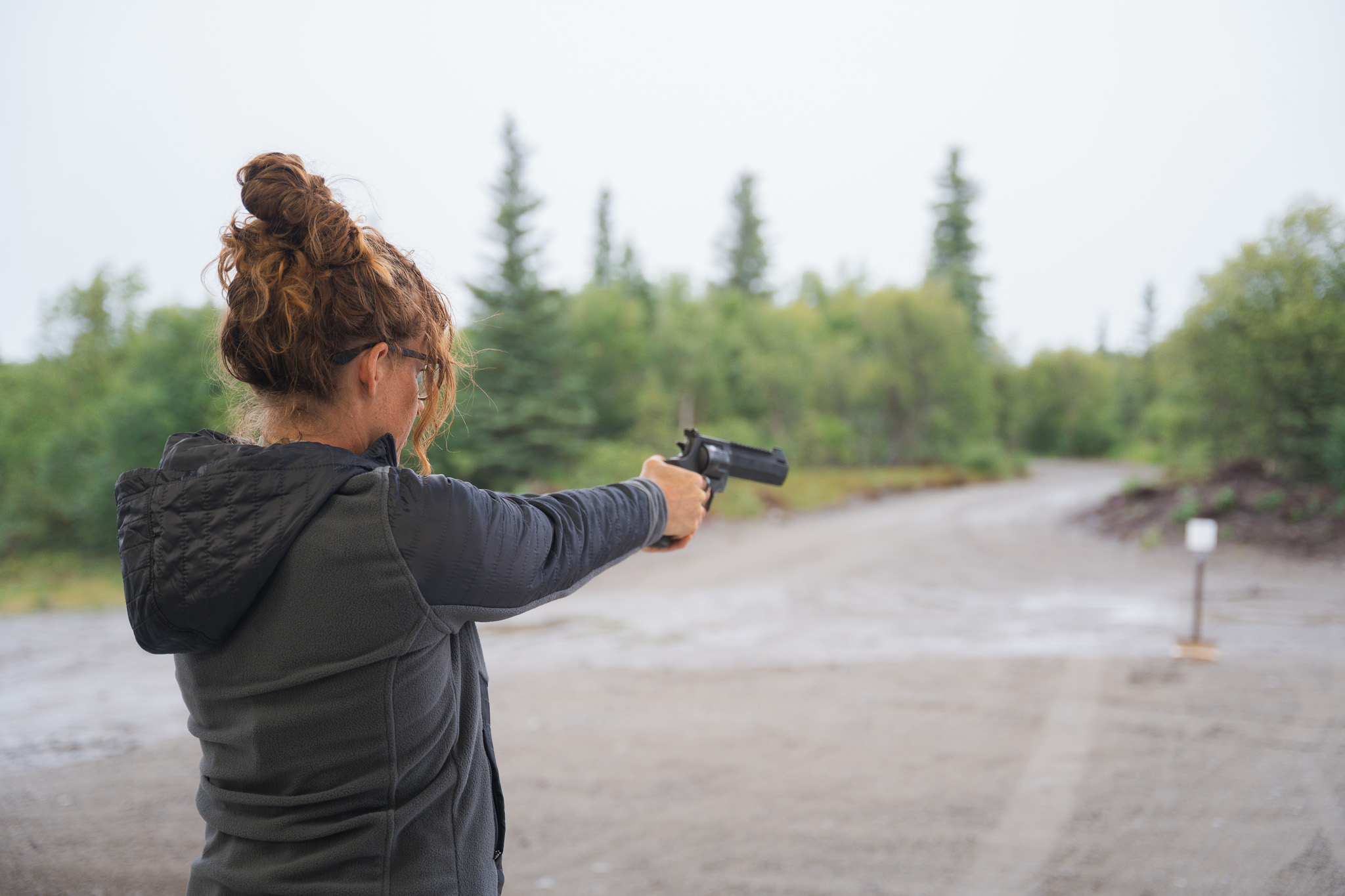 woman-shooting-taurus-raging-hunter-454-casull-alaska Woman firing a Taurus Raging Hunter 454 Casull revolver at an outdoor range in Alaska